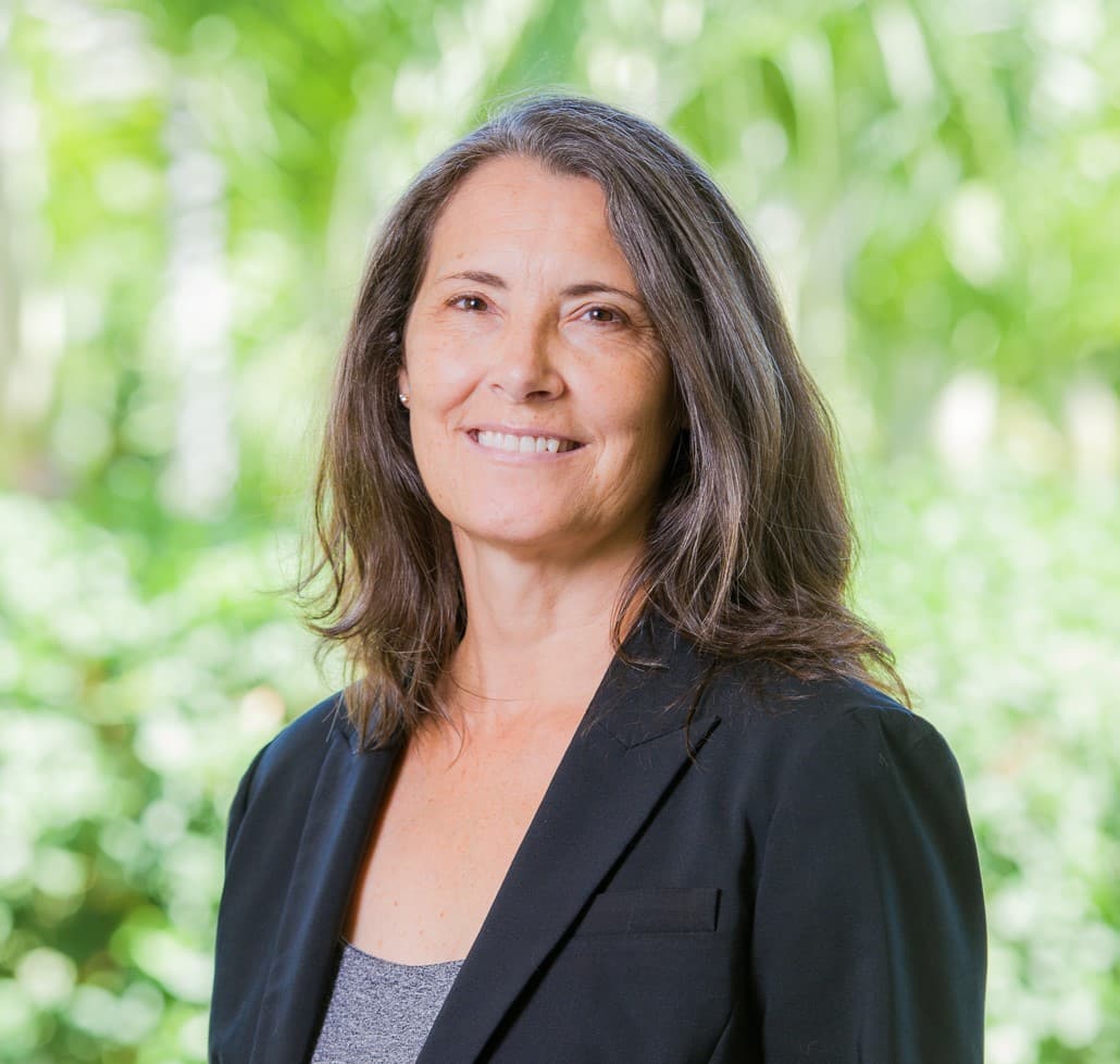 Julie Elting photo Smiling woman in blazer against green background